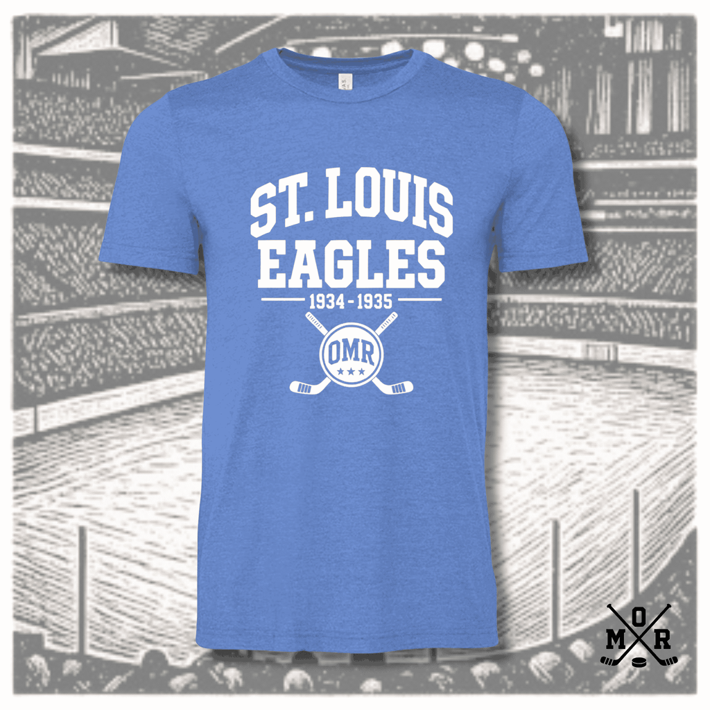 Heathered royal blue vintage St. Louis Eagles hockey t-shirt with white arched text and crossed sticks crest